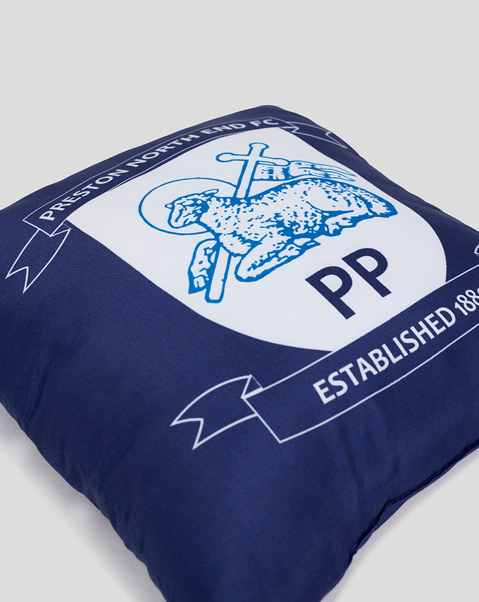 Close-up of blue square cushion showing the Preston North End crest with PP initials.