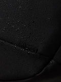 Close-up of black water resistant fabric with droplets on the Castore Core Backpack.