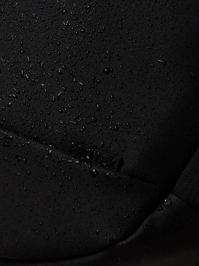 Close-up of black water resistant fabric with droplets on the Castore Core Backpack.