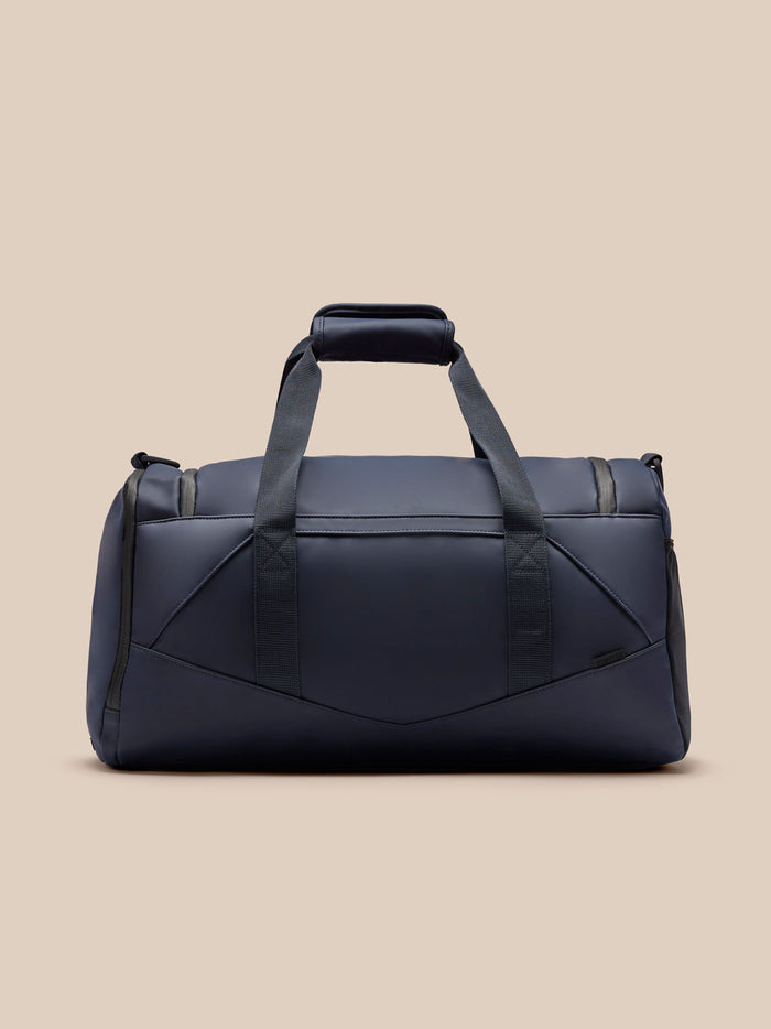 Midnight navy Core Holdall with padded top handle and two straps, full front view.