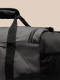 Close up of the gunmetal Core Holdall showing the padded strap and ProTek logo on the bag