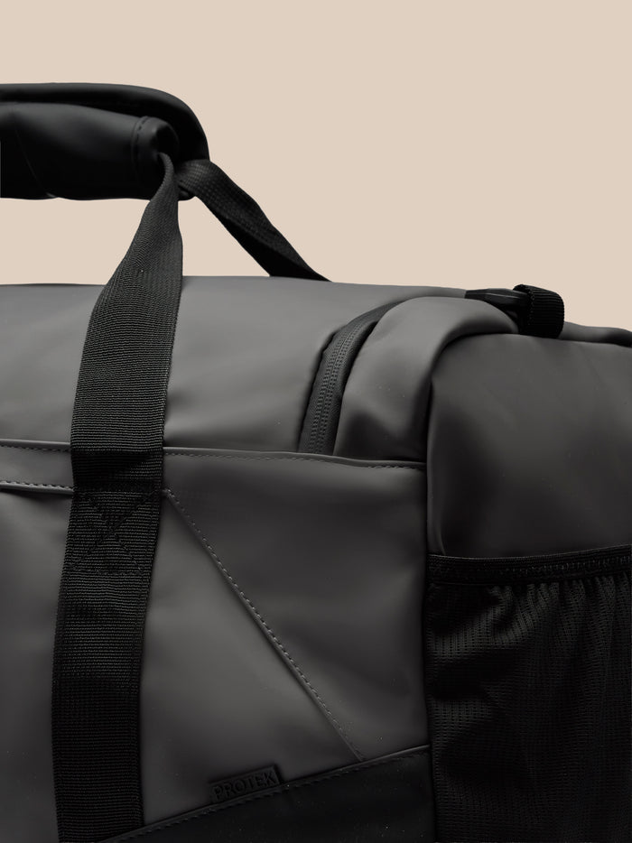 Close up of the gunmetal Core Holdall showing the padded strap and ProTek logo on the bag