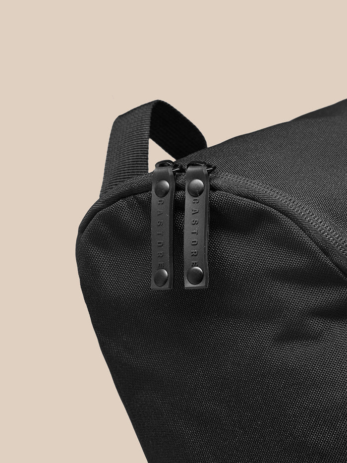 Close up of black Active Boot Bag zipper pulls with CASTORE branding.