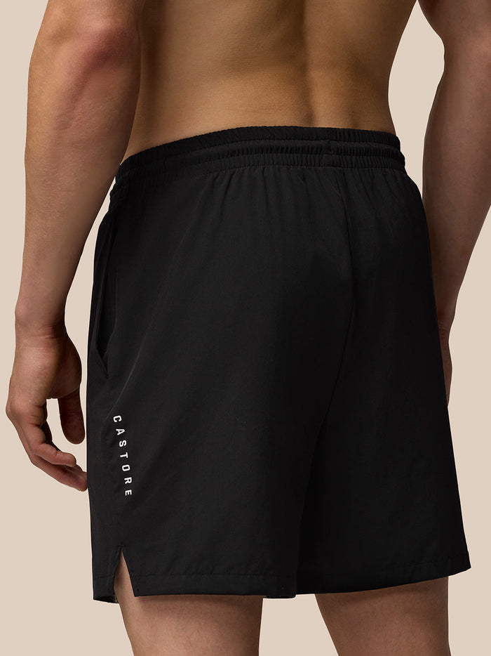Back view of black Adapt Training 6-inch shorts with elastic waistband and branding on the thigh.