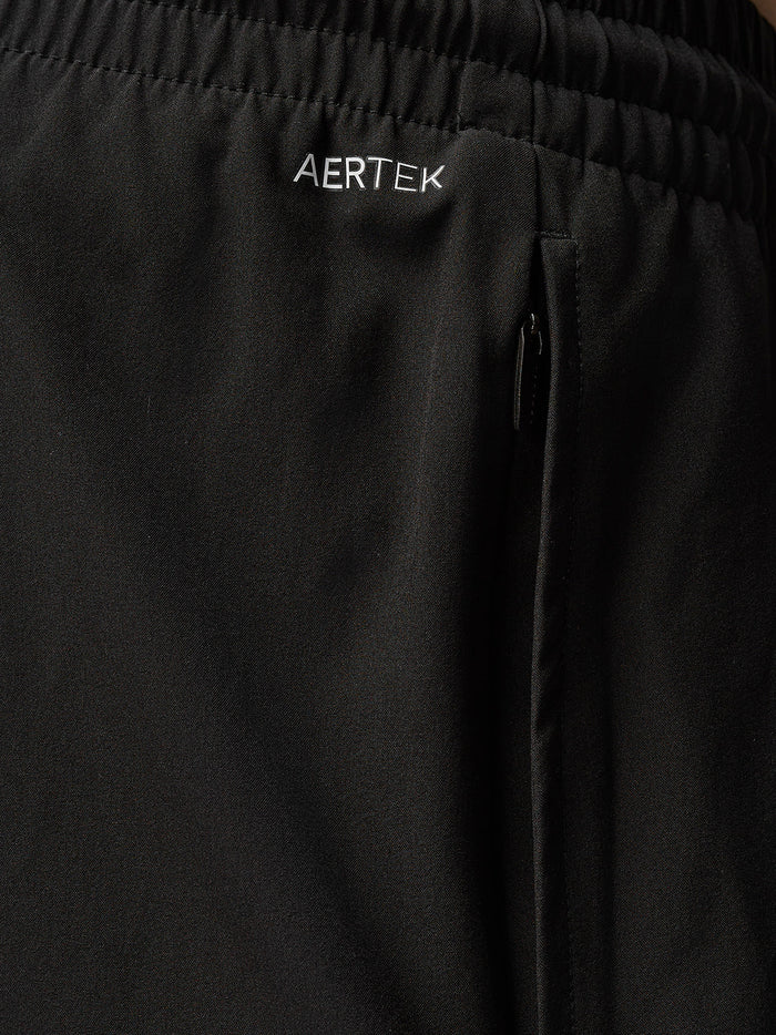 Close-up of zip pocket on black Adapt Training 6-inch shorts with Aertek branding.