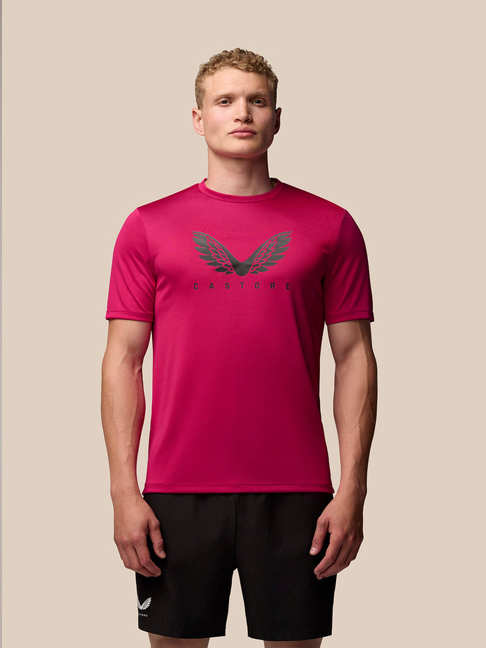 Front view of a male model wearing pink Adapt Training T-Shirt with a Castore wings graphic on the chest