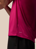 Close-up of pink Adapt Training T-Shirt fabric with AerTek branding at the lower back hem