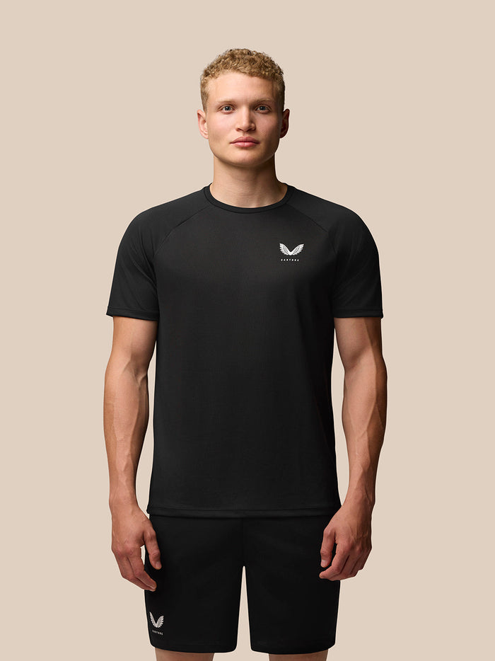 Male model wearing black Adapt Training T-Shirt with Castore logo on the left chest