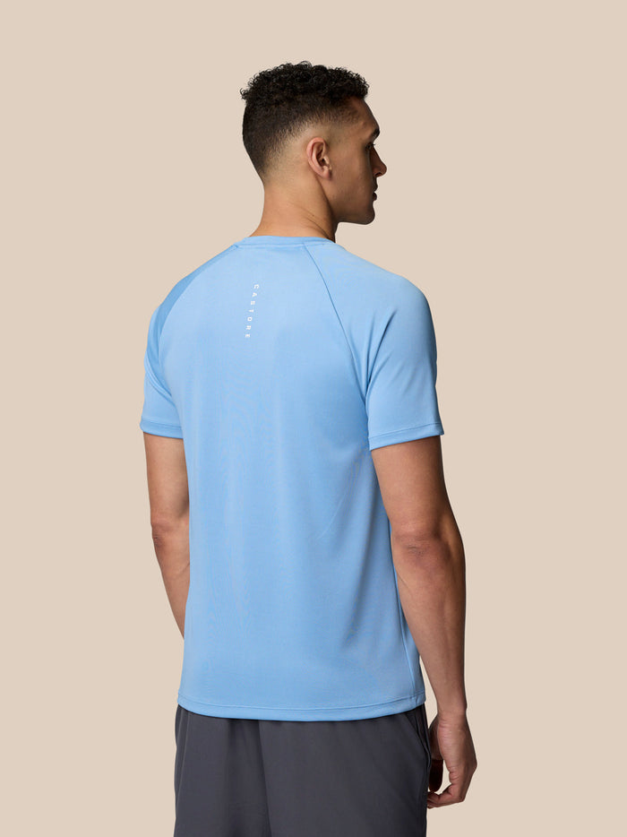 Back view of sky blue Adapt Training T-Shirt showing Castore branding along the spine.