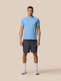Full body shot of a man in sky blue Adapt Training T-Shirt with Castore logo and dark shorts