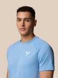 Front view of man wearing sky blue Adapt Training T-Shirt with Castore logo on chest.