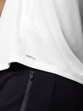 Close-up of white mesh training T shirt fabric with Aertek branding at the hem
