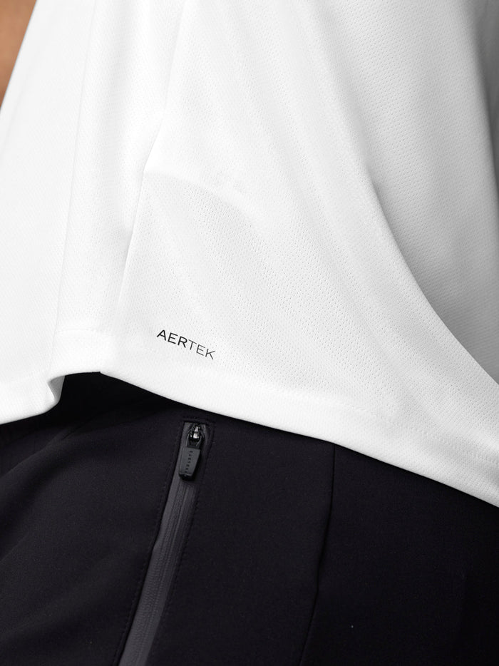 Close-up of white mesh training T shirt fabric with Aertek branding at the hem
