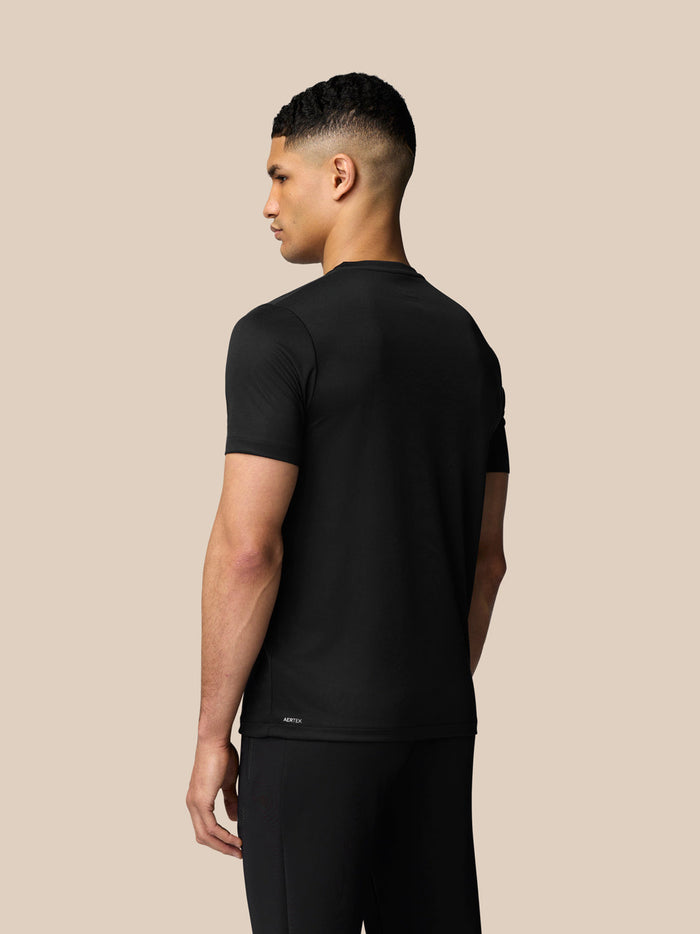 Back view of male model in black graphic training T shirt showing Aertek branding at lower back