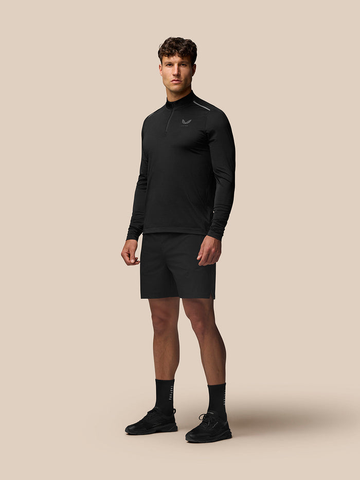 Male model wearing black Apex Training Quarter Zip Top with stand collar and subtle left chest logo