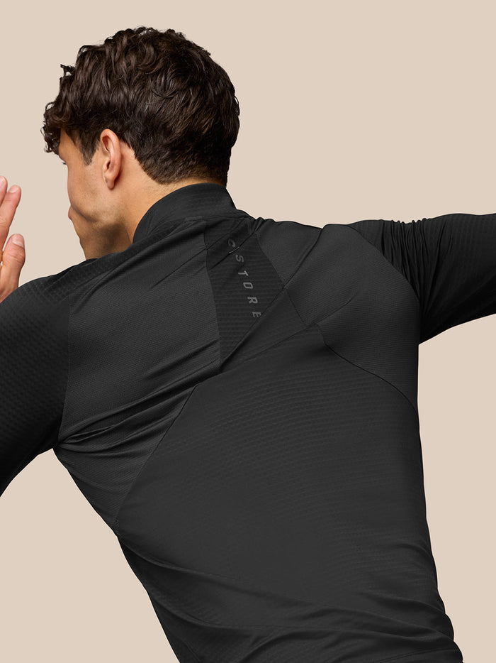 Rear view of black Apex Training Quarter Zip Top with Aeromesh branding along the back panel.