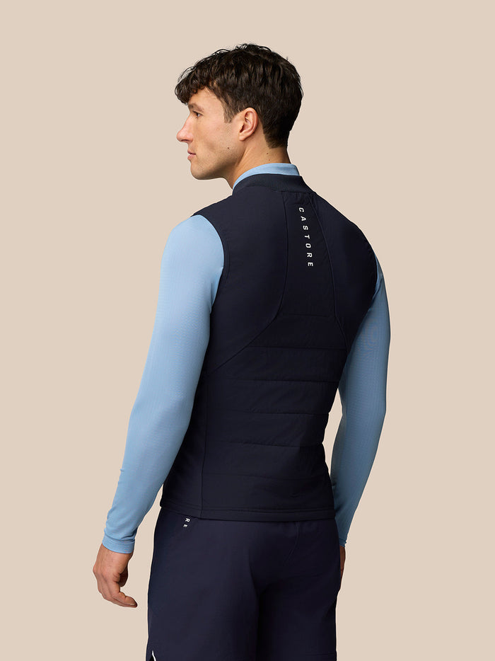 Back view of male model wearing navy Apex Training Gilet with Castore branding along the upper back.