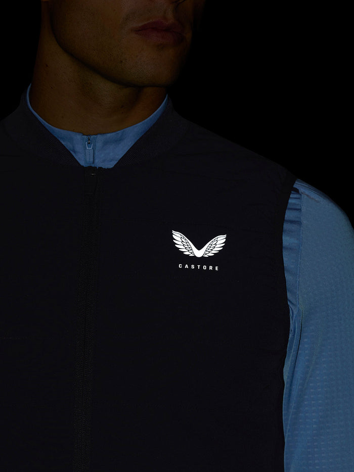 Close-up of navy Apex Training Gilet chest featuring the Castore logo on the left side
