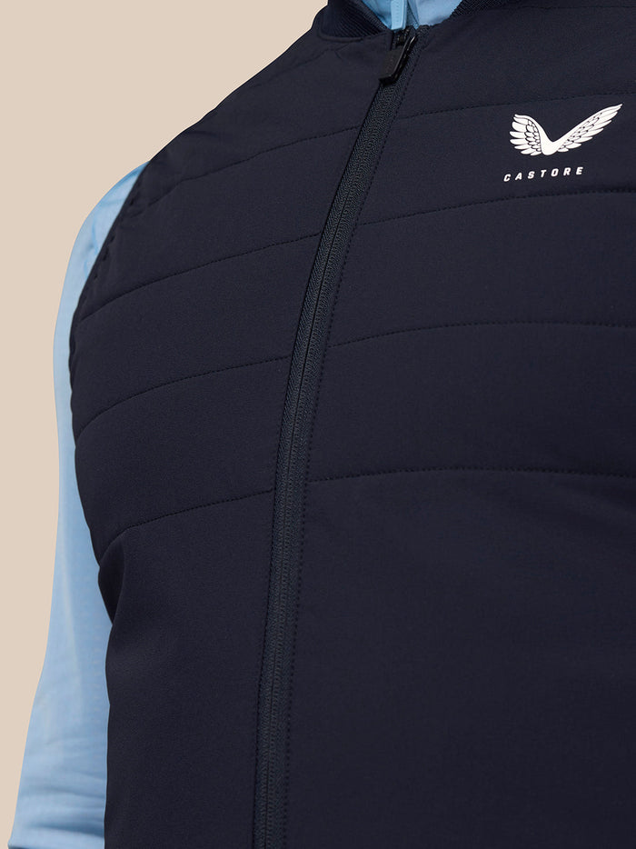 Close-up of navy Apex Training Gilet showing front zipper and Castore branding on the chest