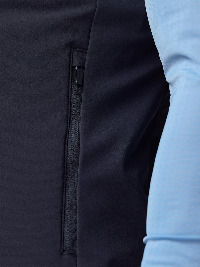 Close-up of navy Apex Training Gilet showing a zippered side pocket