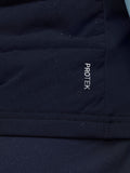 Close-up of navy gilet fabric with ProTek branding visible on the lower back