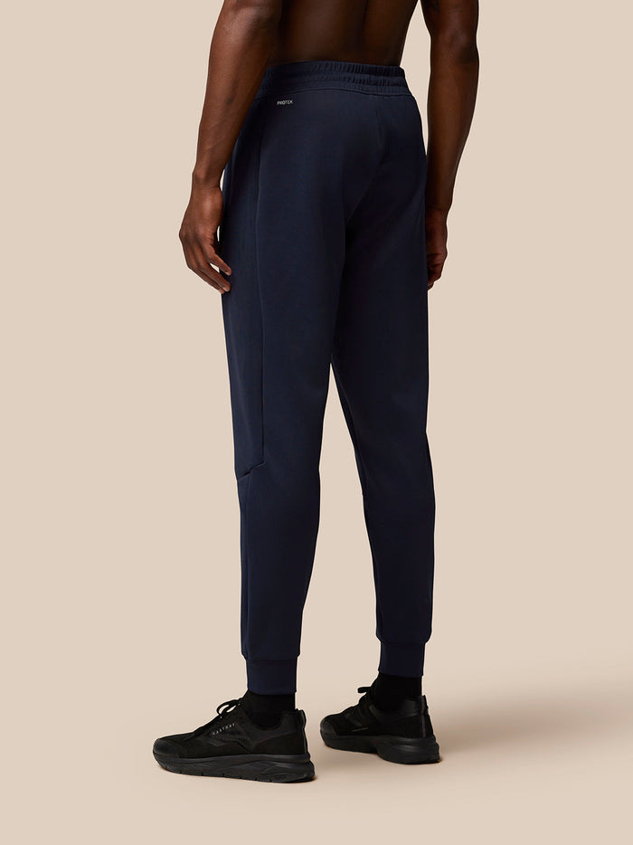 Rear view of navy joggers showing waistband with Protek branding at the back.