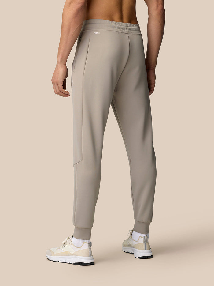 Taupe Flex Lifestyle Joggers shown from the back on a model with cuffed ankles