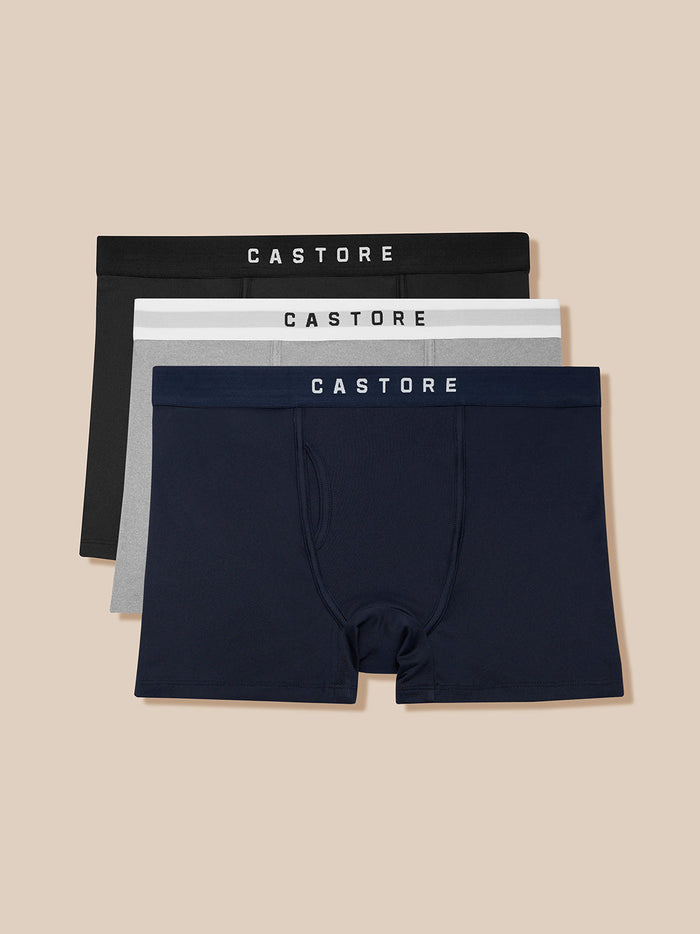 Three pack of Castore Active Boxer Shorts in navy gray and black with CASTORE elastic waistbands.
