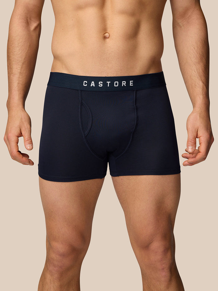 Back view of navy Castore boxer shorts on a male model showing curved stitching and snug waistband