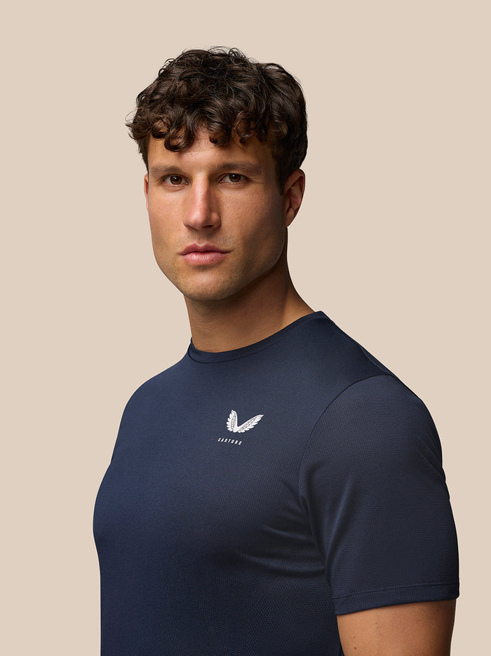 Male model wearing midnight navy Apex Training T Shirt with short sleeves, front view.