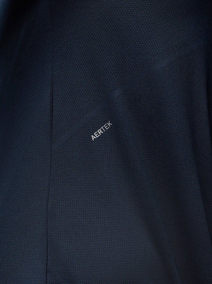 Close-up of navy fabric showing ARTEK branding on the engineered knit texture.