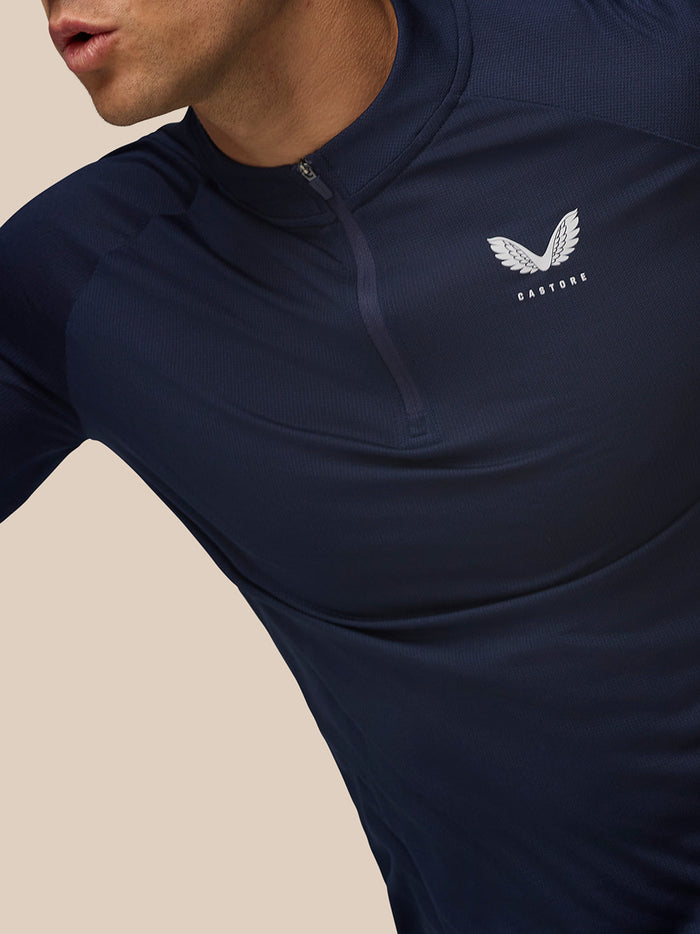 Close-up of Apex Training Quarter Zip Top in midnight navy featuring a stand collar and left chest Castore logo.