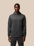 Male model wearing charcoal Flex Lifestyle Full Zip jacket with hood waterproof zips and Castore branding on chest