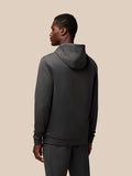 Front view of charcoal Flex Lifestyle Hoodie on a model with hood, Castore logo across chest