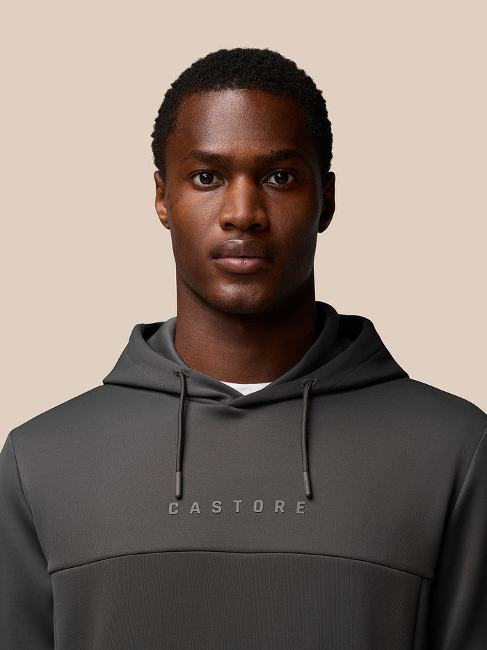 Back view of charcoal Flex Lifestyle Hoodie on a model with hood down and plain back panel