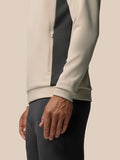 Full-body view of a male model wearing beige Flex Lifestyle Hoodie with color-block side panels.