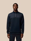 Male model in navy Flex Quarter Zip top with Protek finish and zip pockets visible