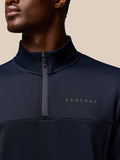 Close-up of navy Castore Flex Quarter Zip collar showing the zipper and chest logo