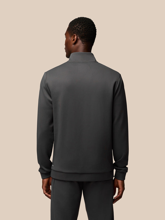 Back view of male model in charcoal Flex Sweatshirt with quarter zip