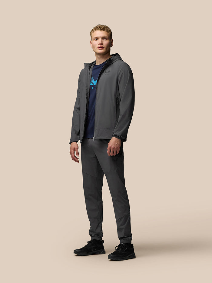 Male model wearing charcoal Lightweight Flex Jacket with full front zip and zip pockets.