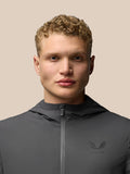 Close up of male model wearing charcoal Lightweight Flex Jacket with zip front and left chest logo.