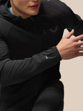 Close up of a model wearing black Flex Winterised Jacket showing Protek cuff branding and front zipper
