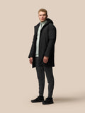 Male model wearing black longline ProTek jacket with hood, front zip and external pockets