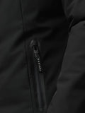 Close-up of black longline jacket fabric with a vertical zip pocket and Castore branding on the zipper.