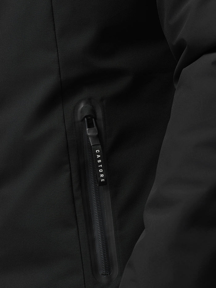 Close-up of the front zipper on the black longline wadded jacket with CASTORE pull.