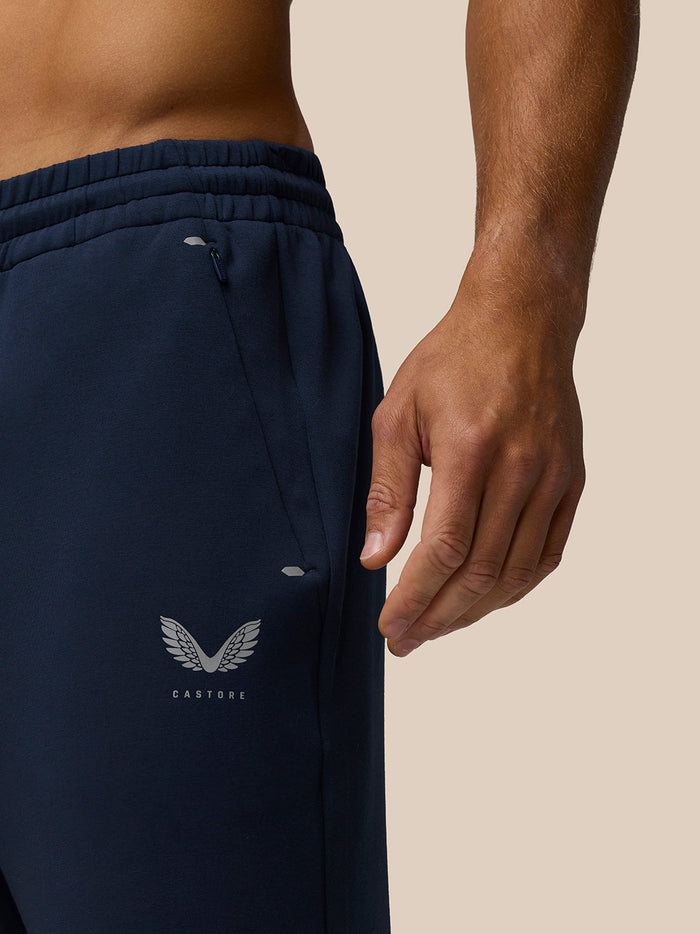 Close-up of navy joggers waist with elastic band and Castore wing logo near hip