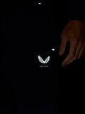 Front close-up showing Castore logo on navy joggers with partial zip pocket