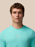 Close-up of a man wearing a light aqua Zone Training T-Shirt with a small chest logo.