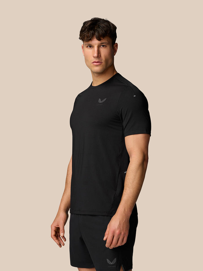 Male model wearing Apex Training T-Shirt in black with reflective Castore branding.