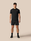 Male model wearing black Apex Training T-Shirt with matching shorts, showcased as athletic gear.